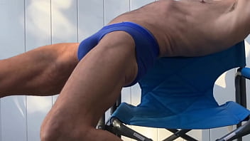 Deep pelvic stretching in blue briefs on blue chair late october 2024