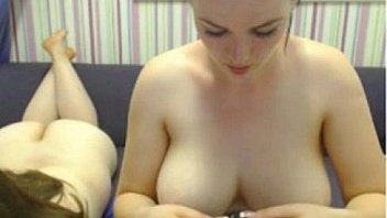 Two busty women rubbing tits on camera