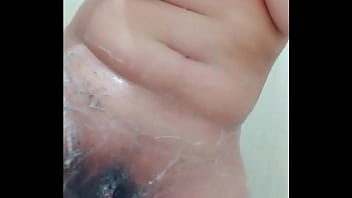 Hot young woman in the shower getting waxed