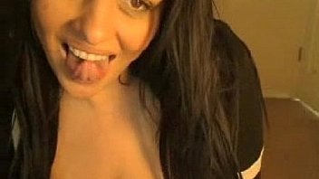 Busty girl sucks on a rubber penis