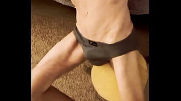 Sneak peak from above stretching in grey briefs on stool and bed