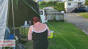 Trashy milf slut pees on the grass in front of other campers at the beach