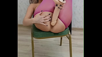 Young girl in torn pink tights frolics on a chair