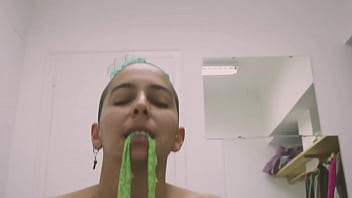 Short tattooed girl with green hair does a hot striptease