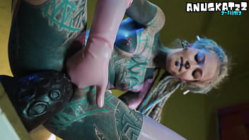 Sexy tattooed stunner in tight latex giving herself a deep double fill with toys