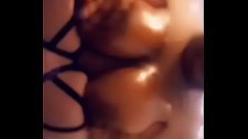 Ebony squeezing shiny boobies