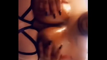 Ebony squeezing shiny boobies