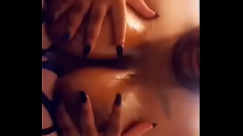 Ebony squeezing shiny boobies
