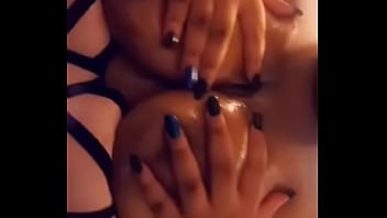 Ebony squeezing shiny boobies