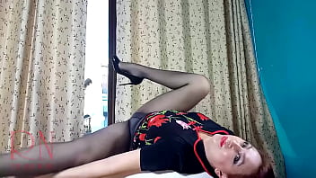 Nice lady in pantyhose and heels striptease at the round table full