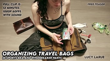 Organizing travel bags in sports bra and windbreaker pants