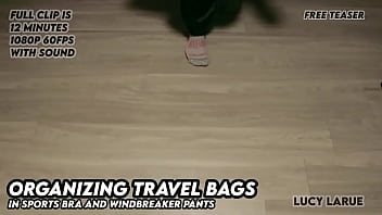 Organizing travel bags in sports bra and windbreaker pants