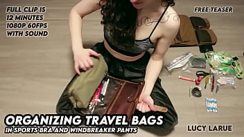 Organizing travel bags in sports bra and windbreaker pants