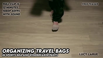Organizing travel bags in sports bra and windbreaker pants