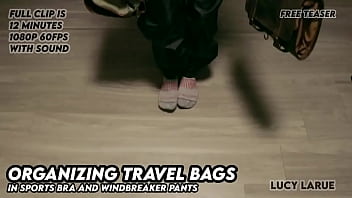 Organizing travel bags in sports bra and windbreaker pants