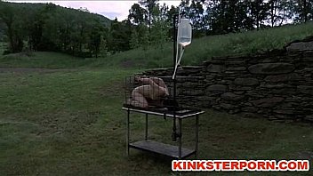Outdoor bdsm cage locked enema slave
