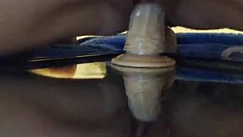 Cute tattooed brunette rides a big dildo