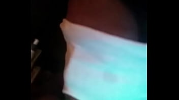 Sucking on a green dildo with mouth mask