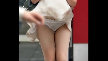 Attractive chinese looking woman got upskirt by the wind