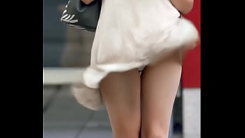Attractive chinese looking woman got upskirt by the wind