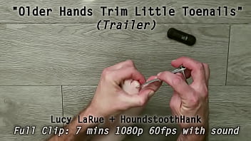 Older hands trim little toenails Older hands trim little toenails