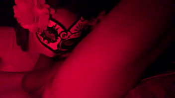 Masked in the red light sucking cock
