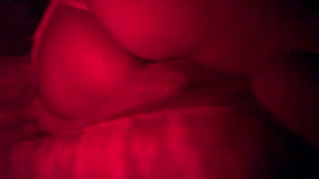 Masked in the red light sucking cock