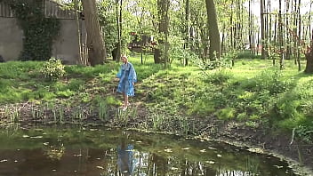 A blonde babe wearing only a plastic raincoat caught by two men in masks in the woods