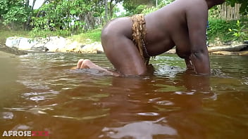 Big tittie zulu aunty washing herself in a tropical forrest river