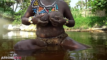 Big tittie zulu aunty washing herself in a tropical forrest river