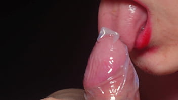 Blowjob In A Condom Very Close Up Red Lips Caress And Lick The Penis thumbnail