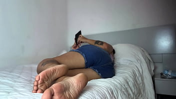 Curvy girl relaxing with a book on bed and farting