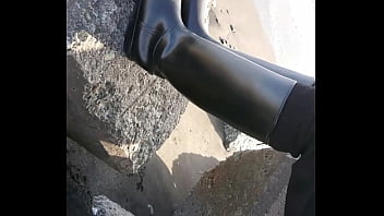 Fetish rubber boots at beach