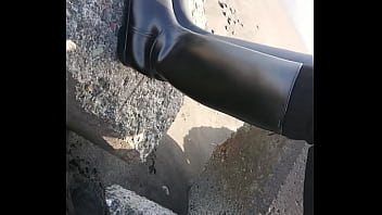 Fetish rubber boots at beach