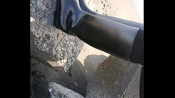 Fetish rubber boots at beach