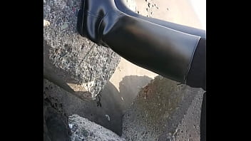 Fetish rubber boots at beach