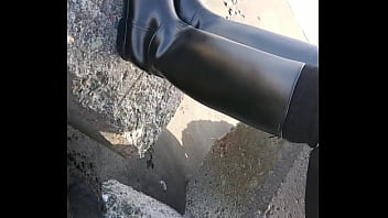 Fetish rubber boots at beach