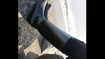 Fetish rubber boots at beach
