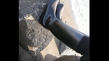Fetish rubber boots at beach