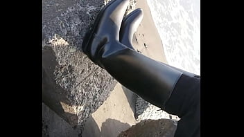 Fetish rubber boots at beach