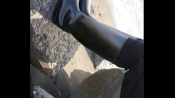 Fetish rubber boots at beach