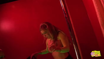 Two fair haired exotic dancers with ample bosoms engage in a physical altercation but then reconcile via intimate contact