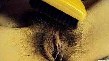 My wife brushing her hairy pussy