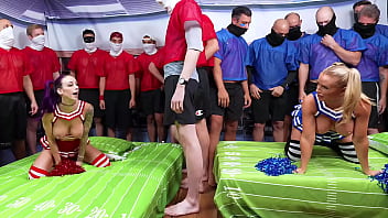 Cheerleaders warm up football players with a blowbang before the gangbang