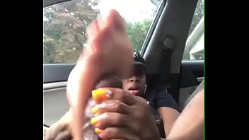 Hot ebony slut footjob to black cock in car