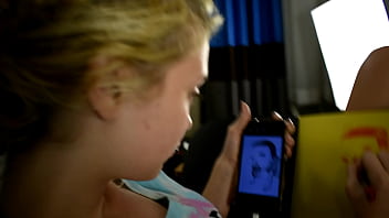 Cute teen porn star drawing a picture while sitting on a bed before she gets used sexually