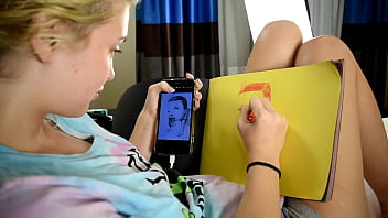 Cute teen porn star drawing a picture while sitting on a bed before she gets used sexually