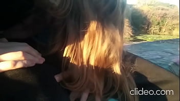 Giving a blowjob plain in daylight outdoors
