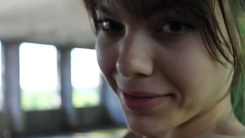 Flexible brunette naked doing sports in an abandoned house