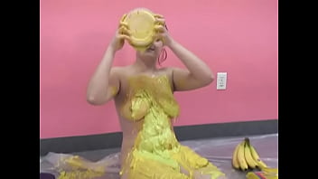 Busty chick pours her body with banana puree